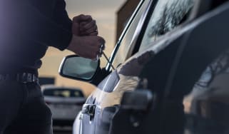 Thief breaking in to car